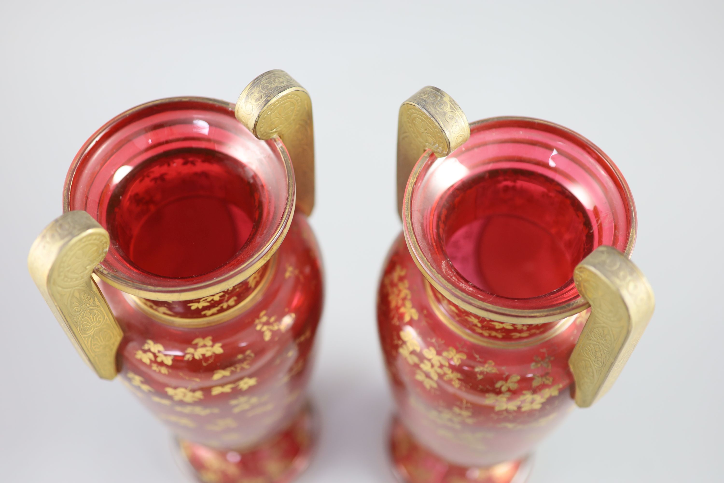 A pair of Bohemian gilt decorated ruby glass two handled vases, late 19th century, height 32cm